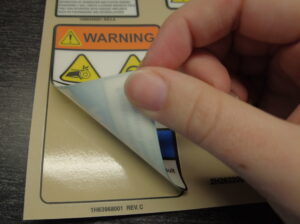 A warning label set made by die cutting at DuraTech Industries using a kiss cut. 